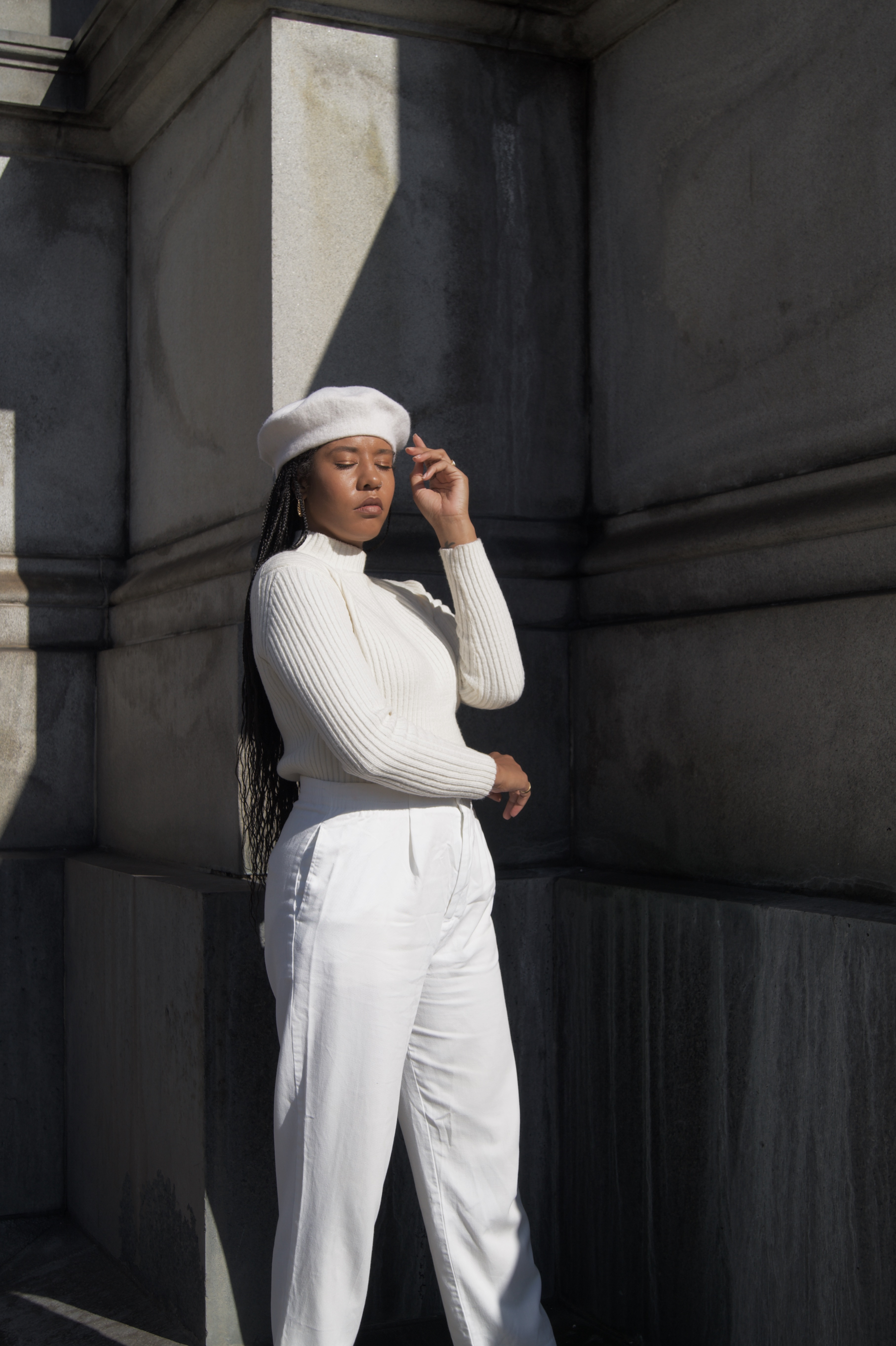 All white winter outfit. Black girl woman in all white street style blogger influencer New York Brooklyn wool beret with braids