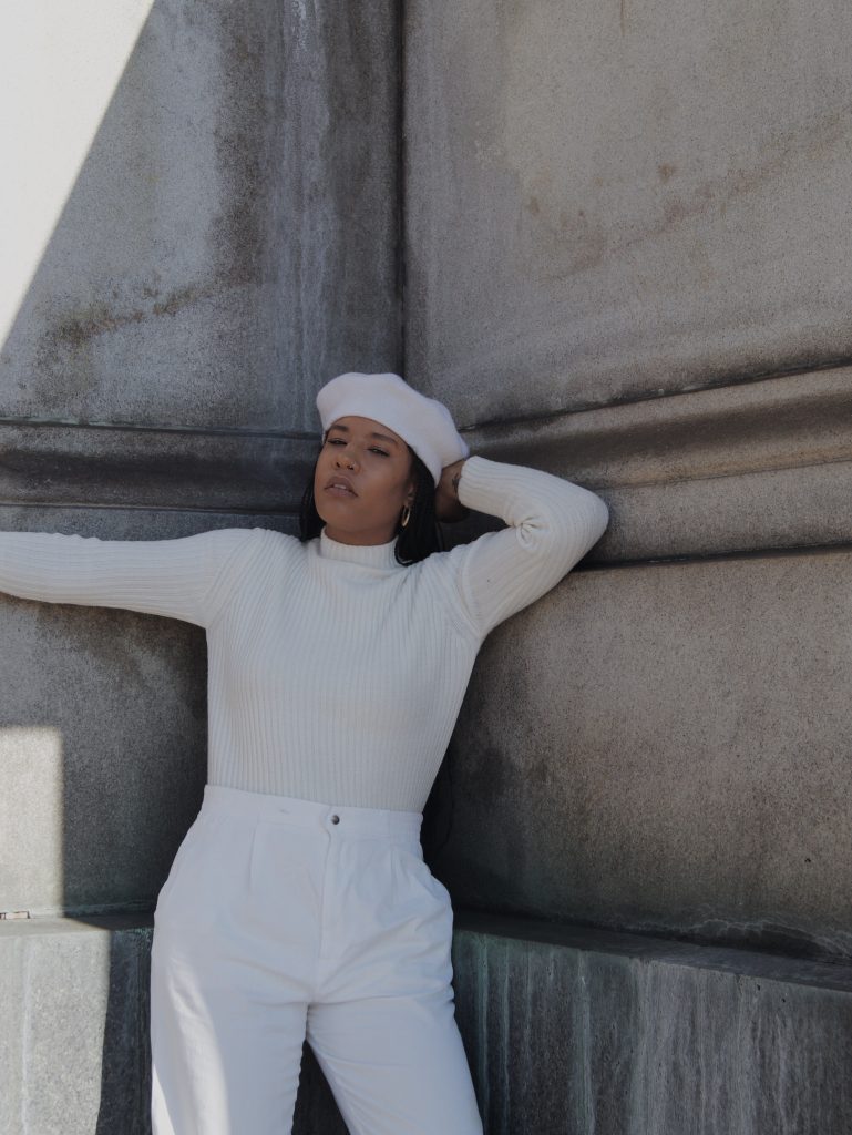 All white winter outfit. Black girl woman in all white street style blogger influencer New York Brooklyn wool beret with braids